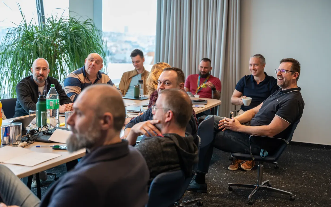 Engineering leaders laughing together during an Academy workshop session