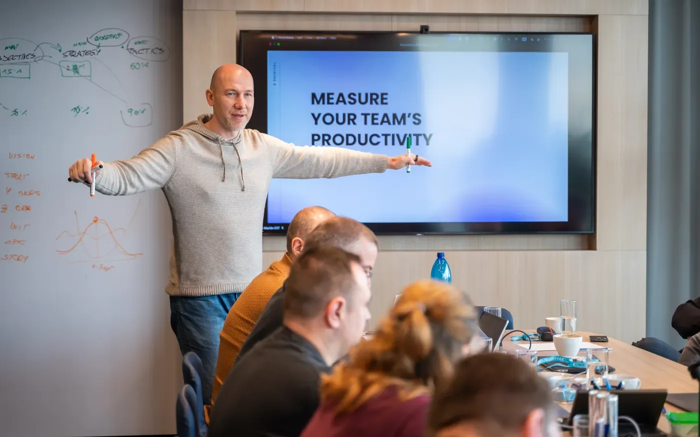 A lecturer walking a cohort through how to measure their team's productivity