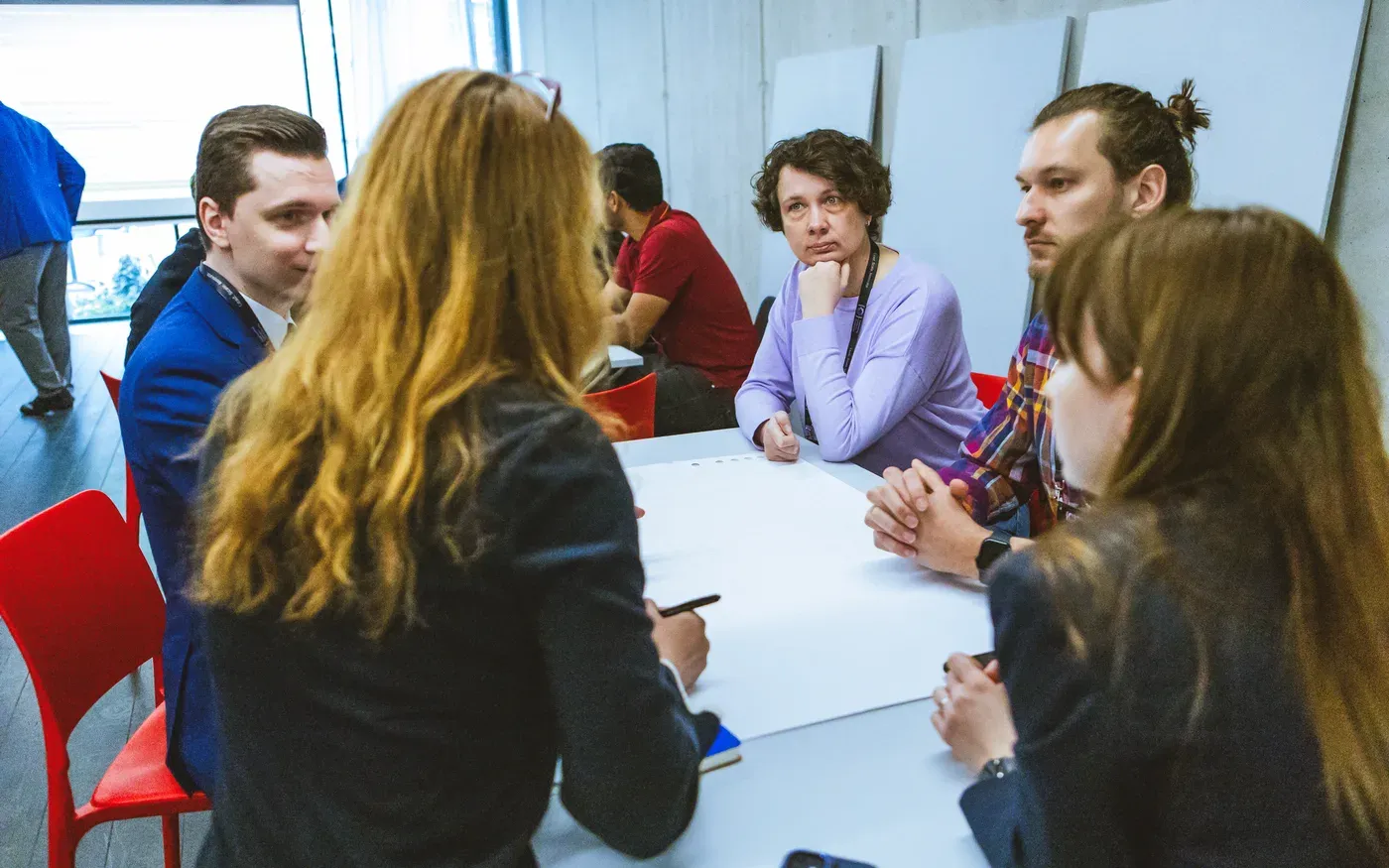 A small group of engineering leaders mapping out their own context around a table
