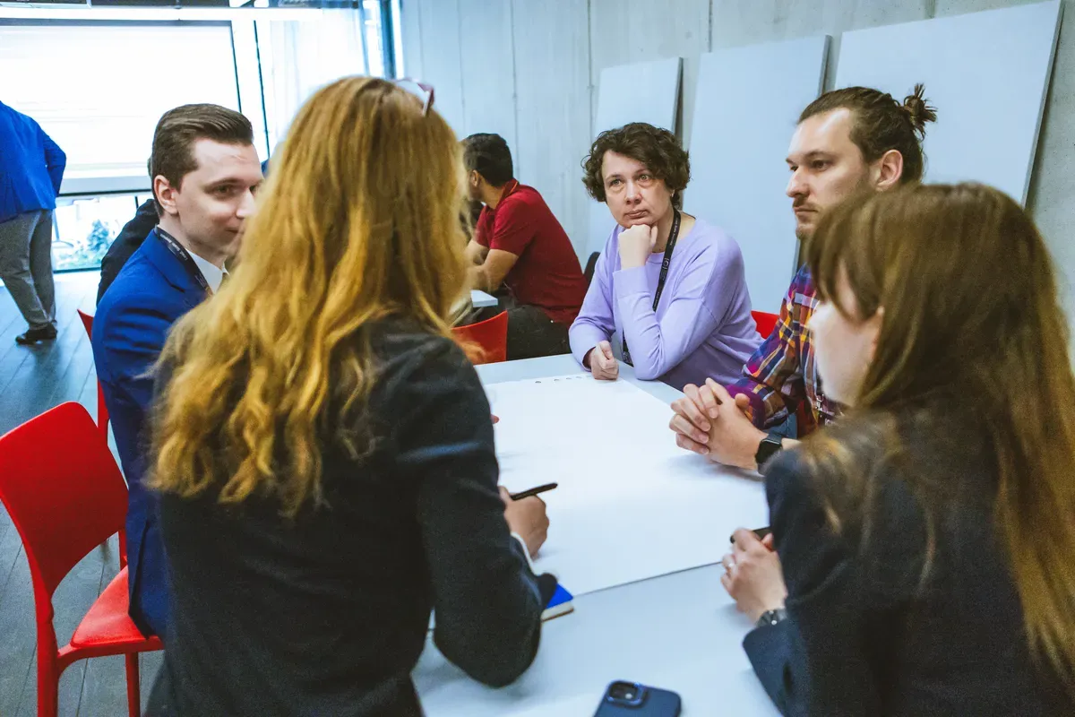 A small group of engineering managers in discussion around a table