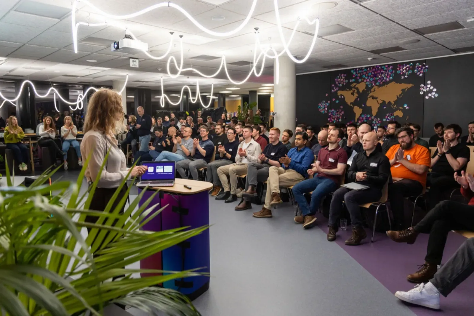 An engineering leader presenting to a full room