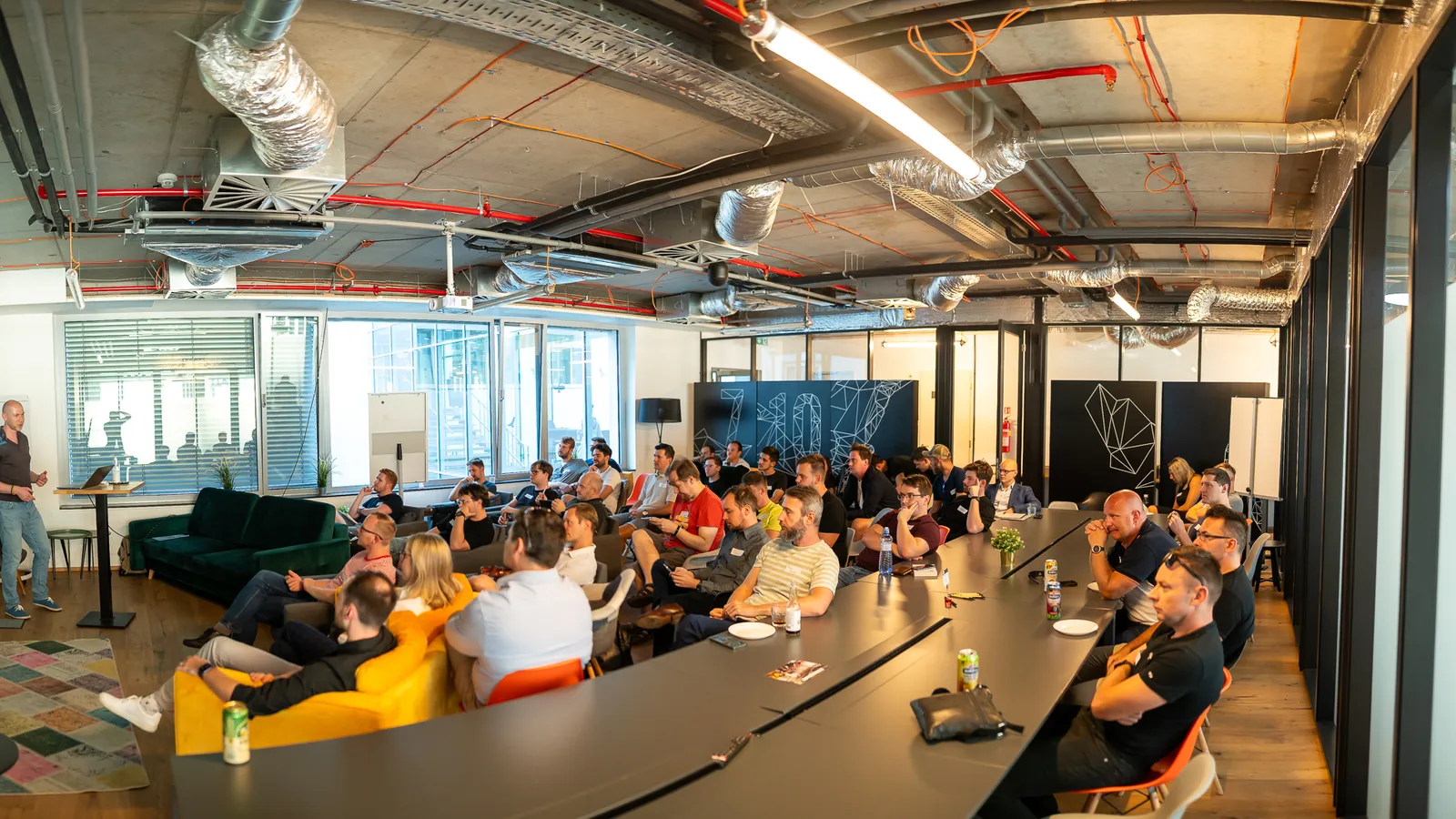 Panorama of an ELC meetup room, speaker and audience