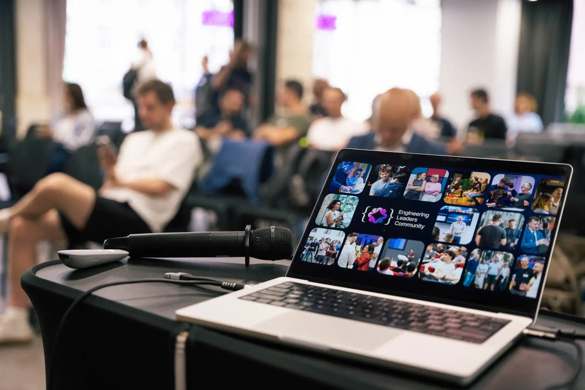The speaker's view at an ELC meetup: microphone and the ELC slide in focus, the room beyond